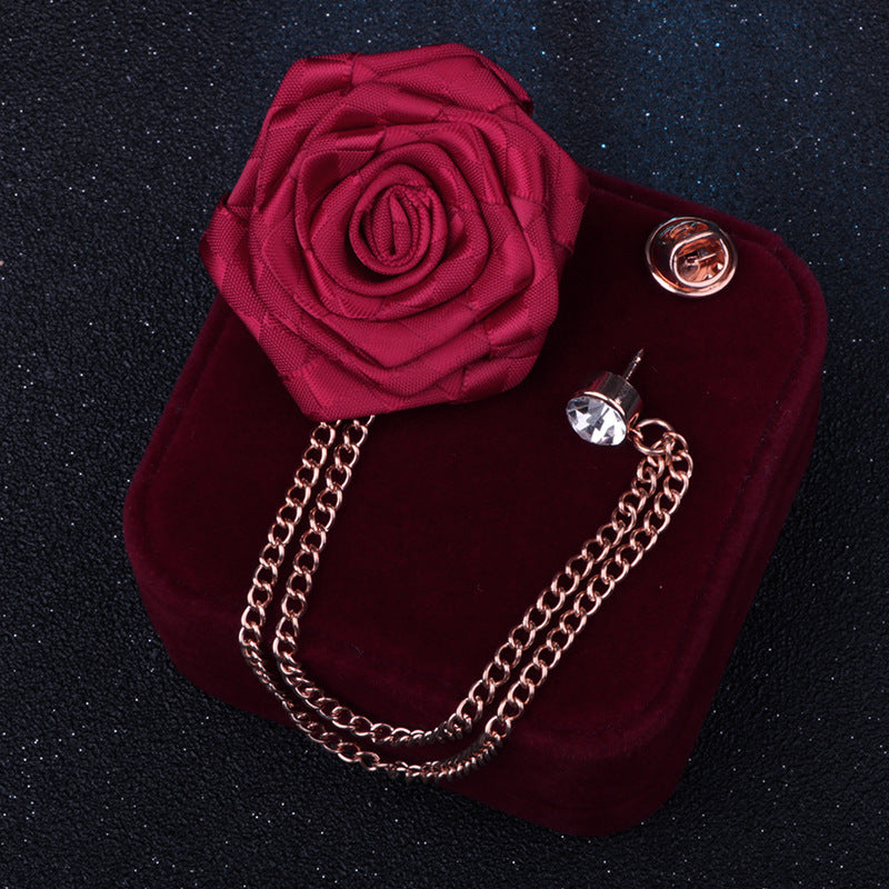 Close-up of camellia floral pin with rhinestones on fabric