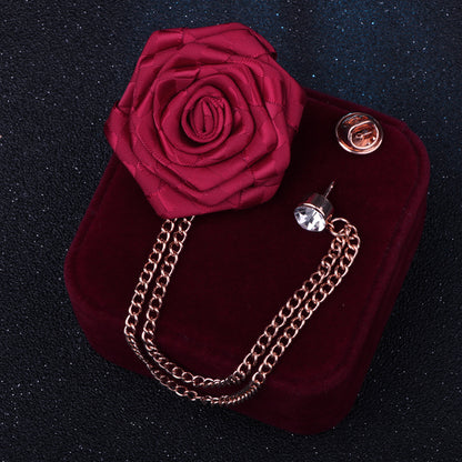 Close-up of camellia floral pin with rhinestones on fabric