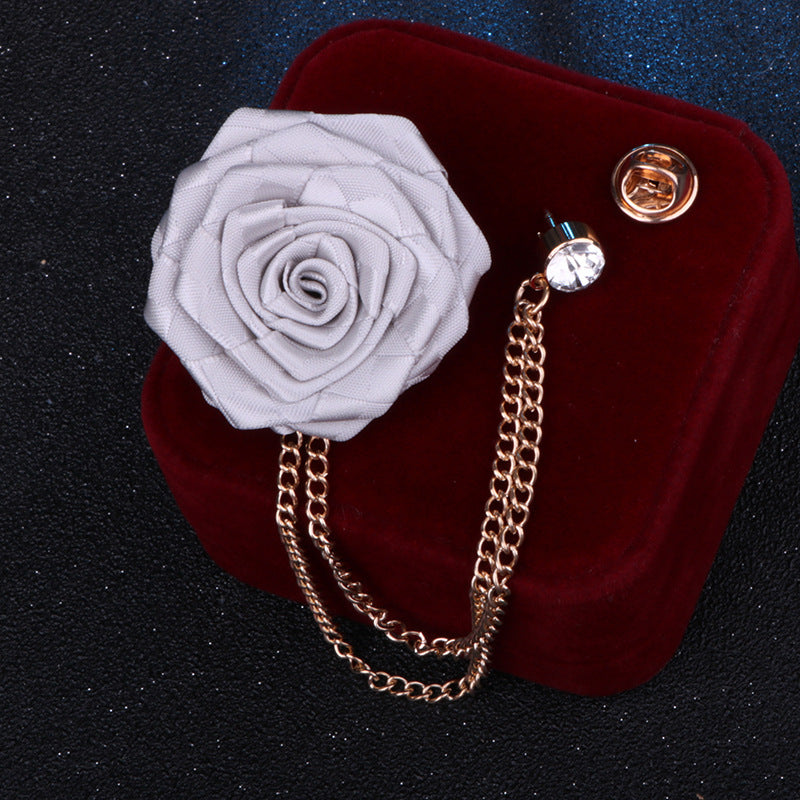 Close-up of camellia floral pin with rhinestones on fabric