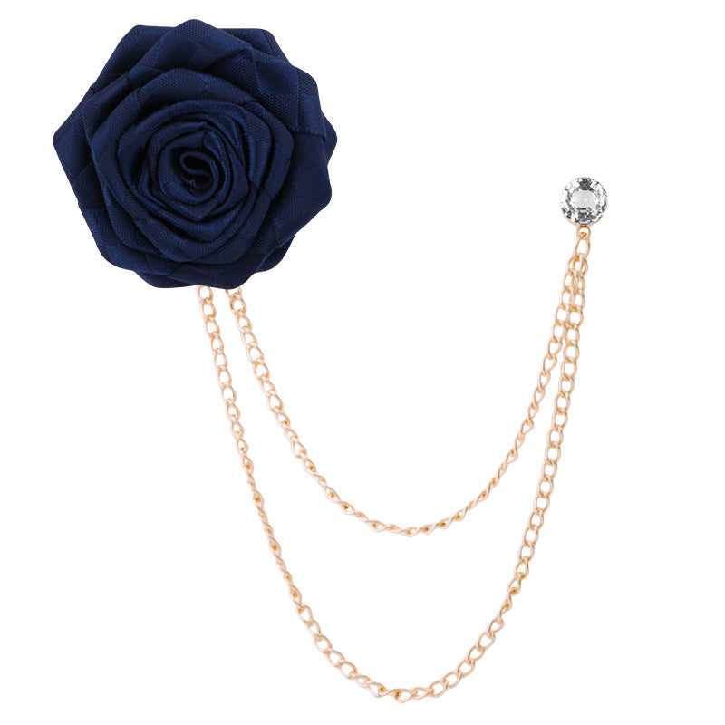 Close-up of camellia floral pin with rhinestones on fabric