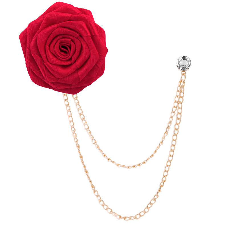 Close-up of camellia floral pin with rhinestones on fabric