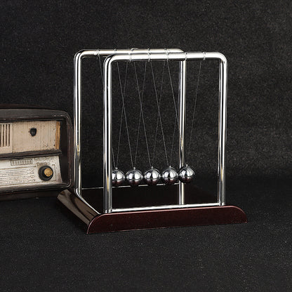 Side view showing motion of Newton's Cradle desk toy