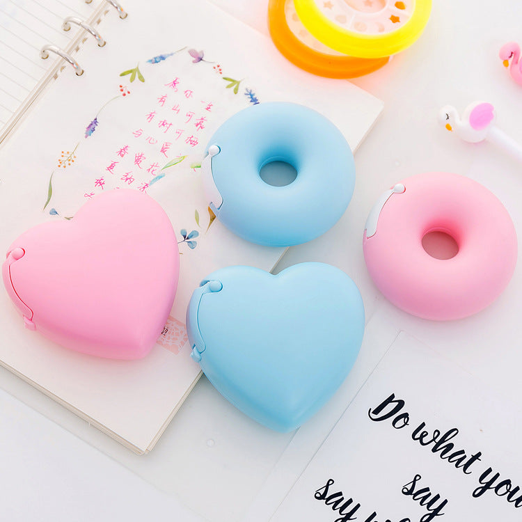 cartoon heart and donut tape dispenser on desk