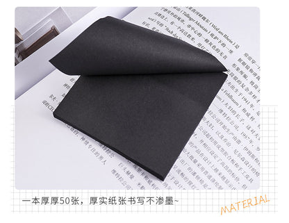 black sticky note pad on desk