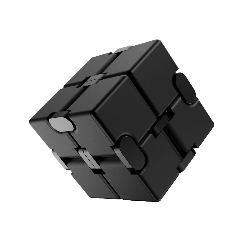 user engaging with patterned metal stress cube