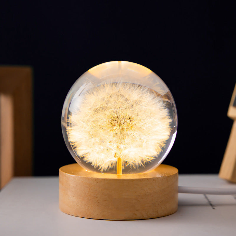 elegant crystal ball with internal dandelion figure and wooden base