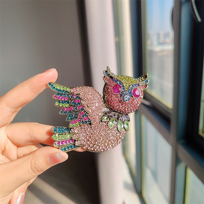 Close-up of rhinestone owl brooch detailing